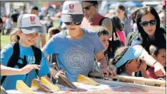  ??  ?? ON A ROLL: Playing roll the coin at the KFC Herald Family Country Fair on Saturday are Talia, 11, and Genevieve Papamichae­l, 12