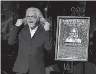  ?? Associated Press ?? ■ Ricky Skaggs accepts his plaque at the 2018 Medallion Ceremony at the Country Music Hall of Fame and Museum on Sunday in Nashville, Tenn.