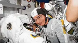  ?? NASA / Associated Press ?? Astronaut Mark Vande Hei inspects a spacesuit at the Internatio­nal Space Station. Vande Hei’s stay at the station will be extended to March.