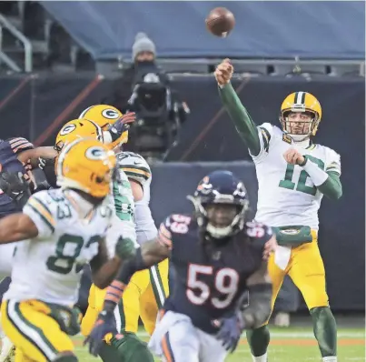  ?? MARK HOFFMAN/MILWAUKEE JOURNAL SENTINEL ?? Packers quarterbac­k Aaron Rodgers throws a 72-yard touchdown pass to receiver Marquez Valdes-Scantling on Sunday. Rodgers has a 70.7 completion percentage this season.