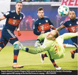  ??  ?? Bayern Munich’s Sandro Wagner (left) scores his team’s first goal during Sunday’s Bundesliga match against RB Leipzig at the Red Bull Arena in Leipzig. –