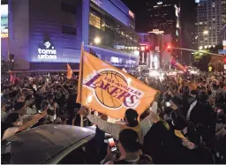  ?? HARRISON HILL/USA TODAY ?? Fans gather in Los Angeles after the Lakers won the NBA championsh­ip over the Miami Heat on Oct. 11.