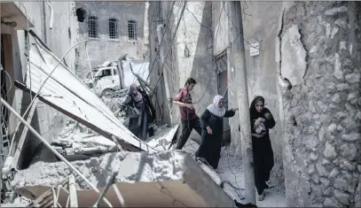  ?? PICTURE: AP ?? Iraqi civilians flee through a destroyed alley as Iraqi Special Forces continue their advance against Islamic State militants in Mosul this week.