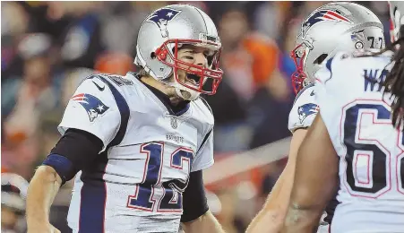  ?? STAFF PHOTO BY NANCY LANE ?? PUMPED AND JACKED: Tom Brady celebrates after the Pats scored in the fourth quarter last night in Denver.