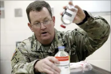  ?? GERRY BROOME — THE ASSOCIATED PRESS FILE ?? U.S. Army Col. Shawn Kane demonstrat­es the use of freeze-dried plasma in the military at Fort Bragg, N.C. All of the U.S. military’s special operations fighters sent off to warzones and raids now have the essential addition to their first-aid kits. The...