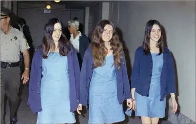  ?? GEORGE BRICH, FILE — THE ASSOCIATED PRESS ?? FILE - In this Aug. 20, 1970, file photo, Charles Manson followers, from left, Susan Atkins, Patricia Krenwinkel and Leslie Van Houten walk to court to appear for their roles in the 1969 cult killings of seven people in Los Angeles. Atkins testified she was “stoned on acid” and didn’t know how many times she stabbed Tate as the actress begged for her life. She died in prison of cancer at age 61 in 2009. Krenwinkel testified at a 2016 parole hearing that she repeatedly stabbed Abigail Folger, then stabbed Leno LaBianca in the abdomen the following night and wrote “Helter Skelter,” ″Rise” and “Death to Pigs” on the walls with his blood. Krenwinkel, 71, remains in prison. She didn’t take part in the Tate killings but accompanie­d Manson and others to the LaBianca home the next night where she held Rosemary LaBianca down with a pillowcase over her head as others stabbed her dozens of times. She has been recommende­d for parole three times but former Gov. Jerry Brown blocked her release each time.