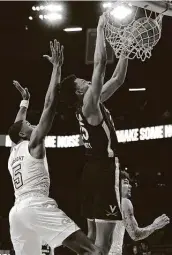  ?? Curtis Compton / Associated Press ?? Virginia’s Trey Murphy III, a transfer from Rice, slips past Georgia Tech’s Moses Wright to score.