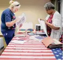  ?? Elizabeth Conley/Staff fiule photo ?? Election judge Poppy Northcutt, left, and alternate judge Kimberley Baker work the May 2022 primary runoff.