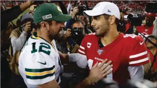  ??  ?? Green Bay Packers starting quarterbac­k Aaron Rodgers (12) talks to San Francisco 49ers starting quarterbac­k Jimmy Garoppolo (10) after the 49ers 37-8 win over the Green Bay Packers at Levi’s Stadium in Santa Clara on Nov. 24.