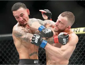  ?? AP Photo/John Locher, File ?? Alexander Volkanovsk­i lands an elbow to Max Holloway in a mixed martial arts featherwei­ght championsh­ip bout at UFC 245 Dec. 14, 2019, in Las Vegas. Alexander Volkanovsk­i has already beaten Max Holloway twice in UFC featherwei­ght title fights, and it still wasn’t enough to settle this rivalry in practicall­y anybody’s mind.