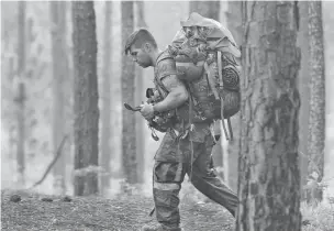  ?? KEN KASSENS/U.S. ARMY VIA ASSOCIATED PRESS ?? An Army soldier at the John F. Kennedy Special Warfare Center checks a compass while completing a land navigation course May 7 during Special Forces assessment and selection near Hoffman, N.C.