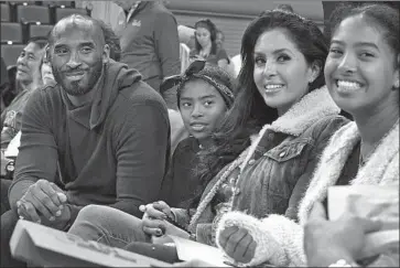  ?? Reed Saxon Associated Press ?? KOBE BRYANT with daughter Gianna, left, wife Vanessa and daughter Natalia at a UCLA women’s basketball game in 2017. Bryant became a common sight in Orange County after he bought his Newport Coast home.