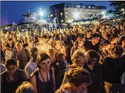  ?? RYAN CHRISTOPHE­R JONES / THE NEW YORK TIMES ?? A moment of silence is observed Friday at a vigil for the victims of the shooting at the Capital Gazette in Annapolis, Md. The crowd held candles in the fading light and stifling heat.