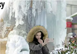  ?? ?? People take photos at the frozen water fountain at Bryant Park in New York on January 5, 2018. The National Weather Service said that very cold temperatur­es and wind chills will follow for much of the eastern third of the US through the weekend. AFP / Jewel Samad