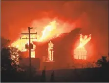  ??  ?? SIGNORELLO ESTATE winery burns in October 2017. Local businesses struggle to encourage visitors to return without reminding them about the current fire threat or the 2017 conflagrat­ion.