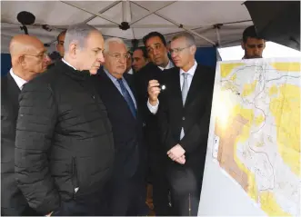  ?? ( Haim Zach/ GPO) ?? PRIME MINISTER Benjamin Netanyahu and US Ambassador to Israel David Friedman, who yesterday said the US ‘ will help Israel formalize its boundaries, including communitie­s in Judea and Samaria,’ examine a map of West Bank settlement­s during a tour in February.