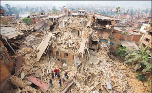  ?? (AP) ?? In this April 26, 2015 file photo, rescue workers remove debris as they search for victims of an earthquake in Bhaktapur near Kathmandu, Nepal.