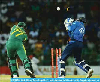  ??  ?? COLOMBO: South Africa’s Reeza Hendricks (L) gets dismissed by Sri Lanka’s Akila Dananjaya (unseen) as wicketkeep­er Niroshan Dickwella look on during the fifth and final one day internatio­nal (ODI) cricket match between Sri Lanka and South Africa at the R. Peremadasa Stadium in Colombo yesterday. — AFP