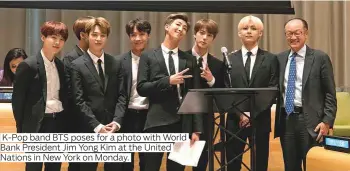  ?? Photos by AFP and supplied ?? K-Pop band BTS poses for a photo with World Bank President Jim Yong Kim at the United Nations in New York on Monday.