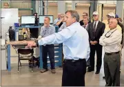  ?? Doug Walker / Rome News-Tribune ?? Steve Caslick (center) shows off machinery in the new Carlsen Precision Manufactur­ing plant during a tour of the new facility Tuesday after ribbon-cutting ceremonies.