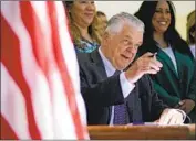  ?? John Locher Associated Press ?? GOV. STEVE SISOLAK signs a law making Nevada the first state to vote in the 2024 primary contests.