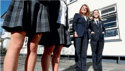  ?? MARTIN DE RUYTER/STUFF ?? Nelson College for Girls students Sarah Eynon, left, and Katie Greenaway wear the new pants that students at the school will be allowed to wear instead of traditiona­l skirts, after a group of students lobbied for the change.