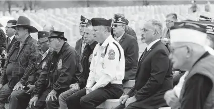  ?? Photos by Jerry Lara / Staff photograph­er ?? Attendees listen to names of the 46, who had no one to claim their remains, and bestow on them the respect and gratitude they earned.