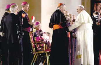  ?? (AP FOTO) ?? CAMEO APPEARANCE. Pope Francis salutes Cardinal Pietro Parolin as he leaves after a vigil in St. Peter’s Square at the Vatican. The pontiff said he is looking for a “sincere, open and fraternal” debate about divisive family issues that opens Sunday...