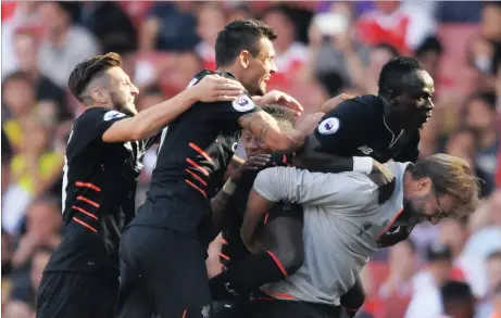  ??  ?? I GOT YOUR BACK, COACH: Jurgen Klopp gives Sado Mane a ride at the Emirates on Sunday.