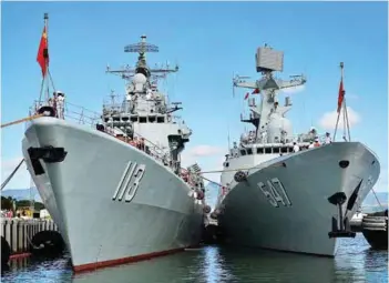  ??  ?? (Top) The Chinese People’s Liberation Army-Navy (PLA-N) sailors at the Qingdao, North Sea Fleet headquarte­rs
in China; (above) PLA-N Jiangkai class frigate Linyi moors alongside the Luhu class destroyer Qingdao