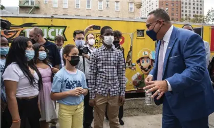  ?? Photograph: Brittainy Newman/AP ?? US education secretary Miguel Cardona with students outside an elementary school in New York, August 2021.