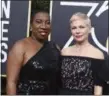  ?? PHOTO BY JORDAN STRAUSS — INVISION, AP ?? Tarana Burke, left, and Michelle Williams arrive at the 75th annual Golden Globe Awards.