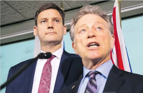  ?? FRANCIS GEORGIAN/PNG ?? Environmen­t Minister George Heyman, right, and Attorney General David Eby announce plans to fight the Trans Mountain pipeline expansion on Thursday in Vancouver. Opposition MLAs are concerned about the message sent to business.