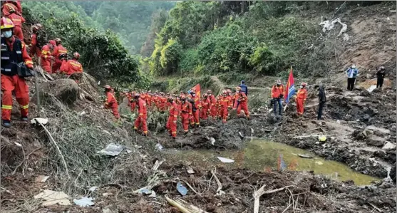  ?? ZHOU HUA / XINHUA ?? Search and rescue workers spare no efforts to recover the black boxes of a crashed jet at the main area of the accident site on March 22 in South China’s Guangxi Zhuang autonomous region. The China Eastern Airlines jet carrying 132 people crashed on March 21, prompting all-out search and rescue efforts.