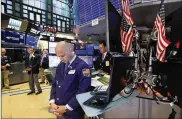  ?? RICHARD DREW / ASSOCIATED PRESS ?? Traders pause for a moment of silence on the floor of the New York Stock Exchange, for the victims of the weekend shootings on Monday.