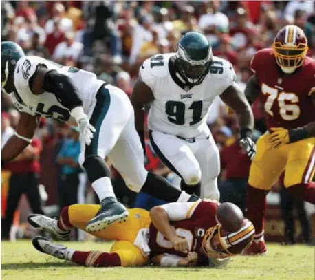  ?? THE ASSOCIATED PRESS — ALEX BRANDON ?? Eagles defensive tackle Fletcher Cox (91), seen pressuring Washington quarterbac­k Kirk Cousins in Week 1, will miss the Eagles trip to take on the Chargers Sunday with a calf injury.