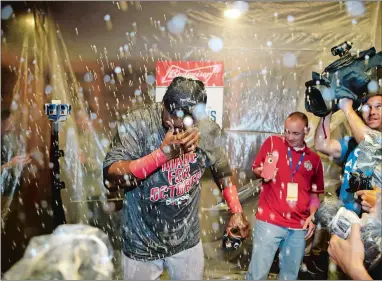  ?? AP PHOTOS BY FRANK FRANKLIN II AND KATHY WILLENS ?? Left, Boston Red Sox designated hitter David Ortiz covers his eyes as he celebrates with teammates after clinching the American League Eastern Division on Wednesday in New York. Below left, teammates douse Mark Teixeira of the New York Yankees with ice...