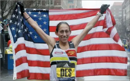  ?? ELISE AMENDOLA — THE ASSOCIATED PRESS ?? Desiree Linden, of Washington, Mich., celebrates after winning the women’s division of the 122nd Boston Marathon on Monday in Boston. She is the first American woman to win the race since 1985.