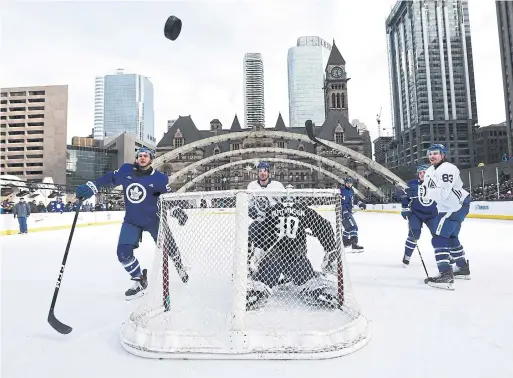  ?? RICHARD LAUTENS TORONTO STAR ?? Thousands of fans braved the cold to watch the Leafs at their annual outdoor practice on the rink at Nathan Phillips Square at City Hall on Thursday.