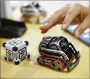  ?? JAE C. HONG / ASSOCIATED PRESS ?? Cozmo’s app called Code Lab lets kids drag and drop blocks of code that control its movements and animations. They can even access facial and object recognitio­n functions enabled by Cozmo’s camera.