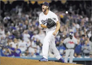  ?? Jae C. Hong ?? Dodgers ace Clayton Kershaw is pumped up after an eighthinni­ng pitch in his Game 2 victory over the Braves on Friday night in Dodger Stadium.The Associated Press