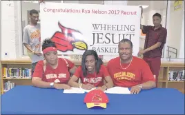  ??  ?? Thomas Stone High School senior Rya Nelson signed her National Letter of Intent to attend Wheeling Jesuit University in West Virginia. Seated, her mother, Latricia Nelson, Rya Nelson, and father Ray Nelson. Standing are her brothers, Ray Nelson, left,...