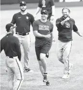  ?? K.C. ALFRED U-T ?? Padres relievers Craig Stammen (center), Trevor Rosenthal and Drew Pomeranz (back left) have some fun while warming up for practice Monday.