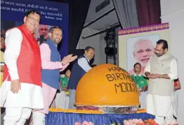  ?? G. N. JHA ?? Union ministers Prakash Javadekar and Mukhtar Abbas Naqvi with Sulabh founder Bindeshwar Pathak in Prime Minister Narendra Modi’s birthday celebratio­n with a huge ‘ laddu’ weighing 568 kgs, in New Delhi on Monday. —