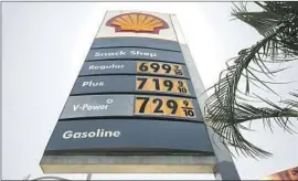  ?? Al Seib For the Los Angeles Times ?? GAS PRICES are posted at a station in L.A. in May. A station manager outside Sacramento lost his job after setting the price at 69 cents a gallon instead of $6.99.