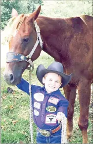  ?? PHOTO BY BRITTANY COFFEE ?? Young cowboy Colton Workman, 5, of Lincoln, received the most votes to be chosen as the fan choice to participat­e in the RFD TV American Rodeo on Feb. 28 at the AT&amp;T Stadium in Arlington, Texas. Colton received almost 65,000 votes, more than twice the number of votes received by the cowboy in second place. He will be honored at the American as a VIP. Colton was born without the lower part of his left arm but started learning to rope when he was 1 year old.