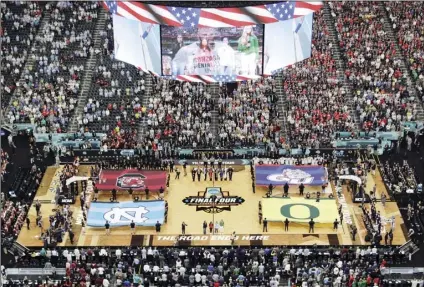  ?? AP PHOTO/MORRY GASH ?? In this April 1, 2017, file photo, fans stand as they observe the national anthem before the Final Four in the NCAA college basketball tournament in Glendale, Ariz.