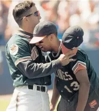  ?? JOHN GAPS III/AP ?? Red Sox: UM’s Alex Cora, right, cries in the arms of a teammate after the Hurricanes lost to LSU in the 1996 College World Series.