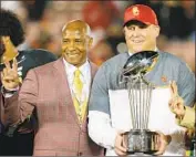  ?? Peter B. Joneleit Associated Press ?? LYNN SWANN and coach Clay Helton celebrate the 2017 Rose Bowl win in happier times for USC.