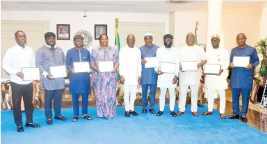  ?? PHOTO: NAN ?? Gov. Nyesom Wike of Rivers State (5th L) and Members of PDP that won elections as National Assembly Members-elect, during the presentati­on of their Certificat­e of Return to the Governor in Port Harcourt on Thursday.